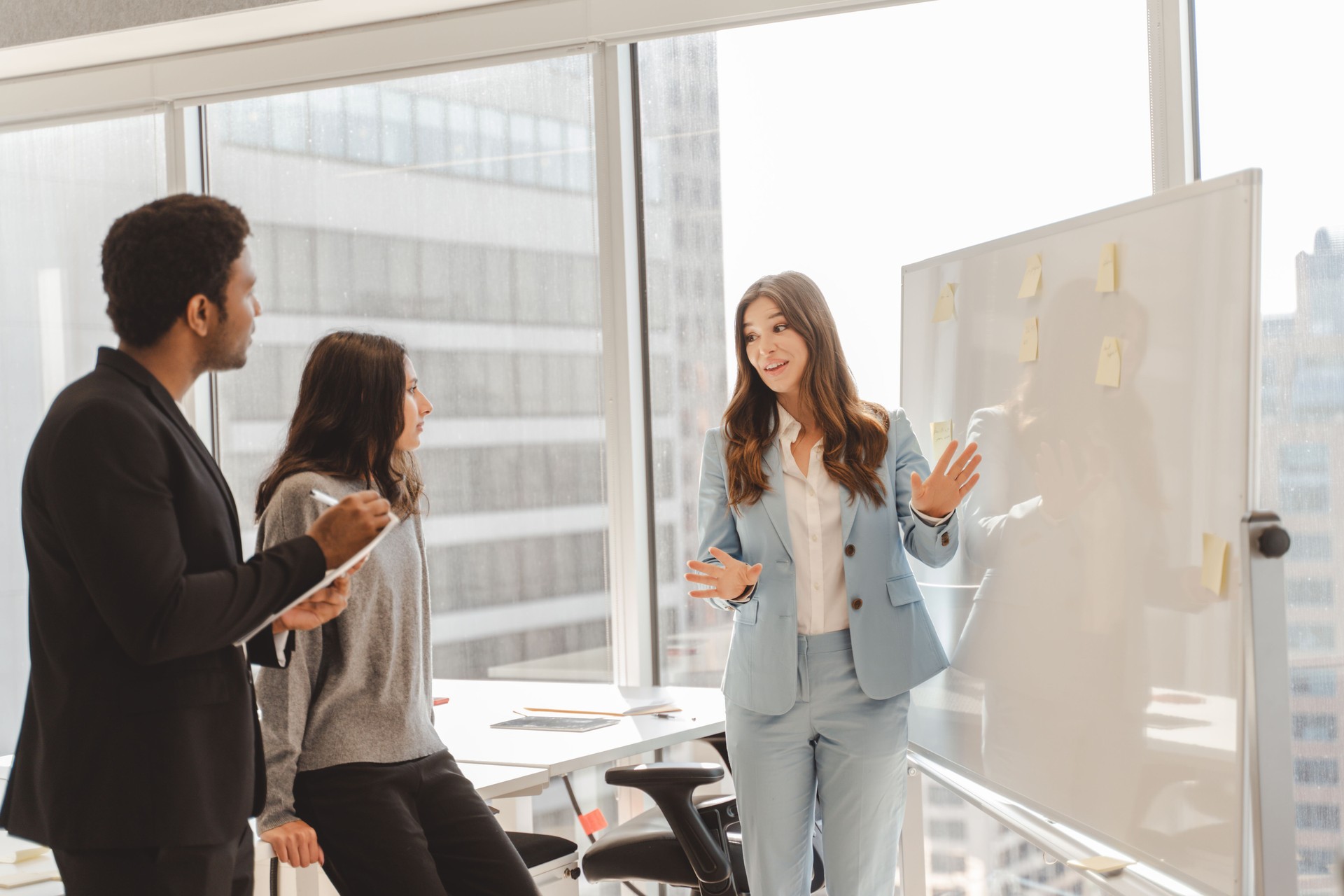 Businesswoman leading a presentation to colleagues in modern office